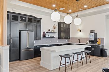 a kitchen with a large white island and black cabinets at Hadley Place Apartments, Pennsylvania, 17025